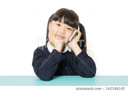 Cute Asian school girl talking on smartphone, communication and connection concept, smiling child portrait on white background Cute Asian school girl talking on smartphone, communication and connection concept, smiling child portrait on white background 142586145