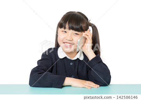 Cute Asian school girl talking on smartphone, communication and connection concept, smiling child portrait on white background Cute Asian school girl talking on smartphone, communication and connection concept, smiling child portrait on white background 142586146