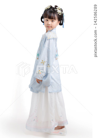 Full length profile of a young girl wearing a traditional light blue Hanfu dress standing against a seamless white background. Full length profile of a young girl wearing a traditional light blue Hanfu dress standing against a seamless white background. 142586289