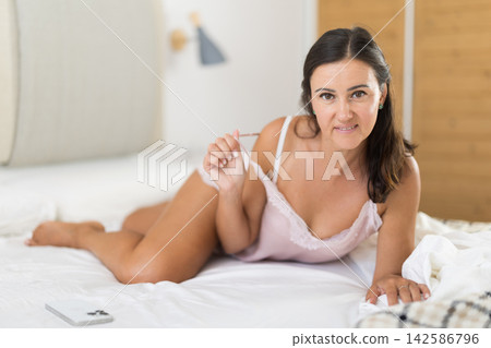 Young woman alone in bedroom, posing and enjoy home time Young woman alone in bedroom, posing and enjoy home time 142586796