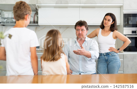 Parents scold their children in kitchen at home Parents scold their children in kitchen at home 142587516