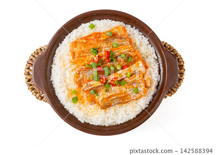 Chinese claypot rice topped with spicy braised ribbonfish fillets on white background Chinese claypot rice topped with spicy braised ribbonfish fillets on white background 142588394
