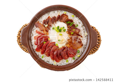 Cantonese claypot rice topped with assorted cured meats, Chinese sausage and fried egg Cantonese claypot rice topped with assorted cured meats, Chinese sausage and fried egg 142588411