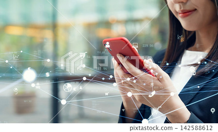 Women using smartphones in the city and digital networks Women using smartphones in the city and digital networks 142588612