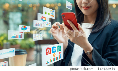 A woman using a smartphone in the city and business data A woman using a smartphone in the city and business data 142588615