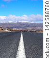 A straight road leading to the snow-capped mountains (Cappadocia) 142588760