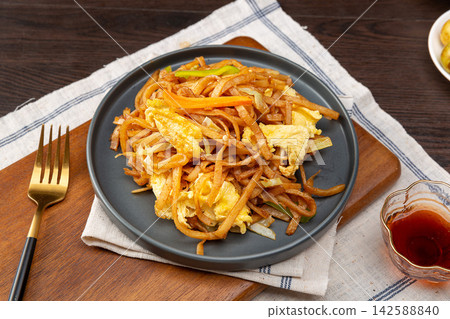 chinese Stir-Fried Shredded Pancakes with Scrambled Eggs, Savory Asian Noodle-Style Street Food chinese Stir-Fried Shredded Pancakes with Scrambled Eggs, Savory Asian Noodle-Style Street Food 142588840