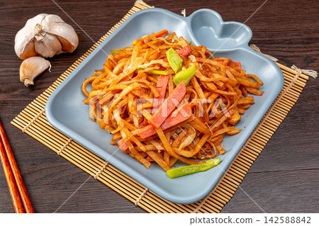 chao Bing, Chinese Stir-Fried Sliced Flatbread with Ham on Wooden Table chao Bing, Chinese Stir-Fried Sliced Flatbread with Ham on Wooden Table 142588842