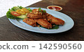 Crispy Fried Chicken Wings with Fried Garlic and Sweet Chili Sauce 142590560
