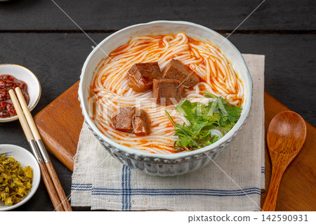 spicy Chinese Rice Noodle Soup with Braised Beef Cubes, Traditional Yunnan Mixian Bowl spicy Chinese Rice Noodle Soup with Braised Beef Cubes, Traditional Yunnan Mixian Bowl 142590931