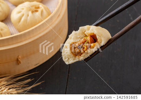 steamed pork and shiitake mushroom xiaolongbao soup dumplings in bamboo steamer, Chinese dim sum steamed pork and shiitake mushroom xiaolongbao soup dumplings in bamboo steamer, Chinese dim sum 142591685