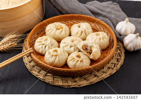 steamed pork and shiitake mushroom xiaolongbao soup dumplings in bamboo steamer, Chinese dim sum steamed pork and shiitake mushroom xiaolongbao soup dumplings in bamboo steamer, Chinese dim sum 142591687