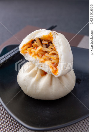 steamed hot and sour shredded potato buns cut open on black plate, Chinese savory baozi steamed hot and sour shredded potato buns cut open on black plate, Chinese savory baozi 142591696