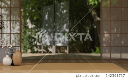 Close up of Japanese style room with wooden table and flower vase across sliding door and greenery. Close up of Japanese style room with wooden table and flower vase across sliding door and greenery. 142591737