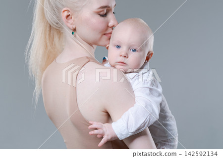 Young Mother Kissing Her Baby Boy on the Head Gently Young Mother Kissing Her Baby Boy on the Head Gently 142592134