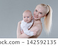 Happy Young Mother Holding Her Baby Boy, Studio Portrait 142592135