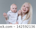 Laughing Young Mother and Her Happy Baby Boy in Studio 142592136
