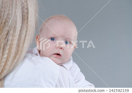 Cute Baby Boy with Blue Eyes Close Up Studio Portrait Cute Baby Boy with Blue Eyes Close Up Studio Portrait 142592139