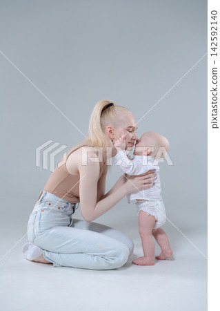 Young Mother and Baby Boy Touching Noses, Tender Moment Young Mother and Baby Boy Touching Noses, Tender Moment 142592140