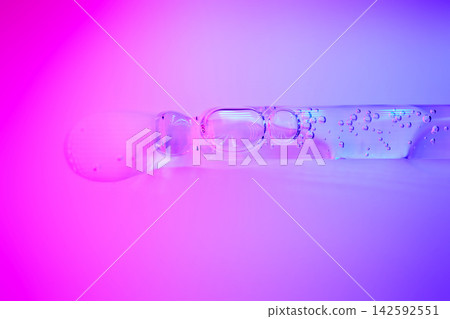 Dropper applying cosmetic serum with bubbles on vibrant background Dropper applying cosmetic serum with bubbles on vibrant background 142592551
