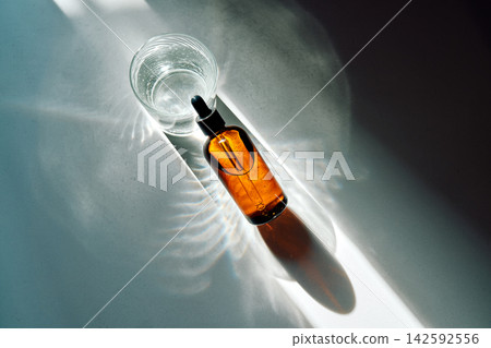 Skincare product bottle and glass with water Skincare product bottle and glass with water 142592556
