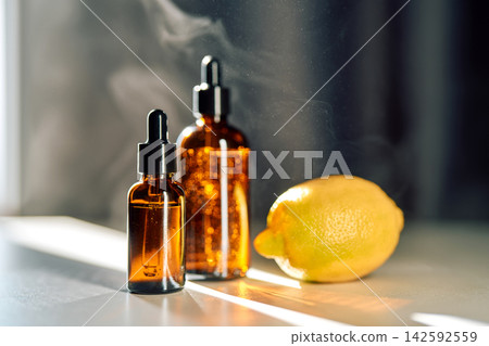 Glass dropper bottles with lemon and natural steam 142592559