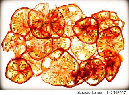 Sun-dried (dried) tomatoes closeup on a white background Sun-dried (dried) tomatoes closeup on a white background 142592627