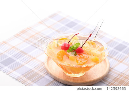 A refreshing fruit punch topped with fruit and cherries. A refreshing fruit punch topped with fruit and cherries. 142592663