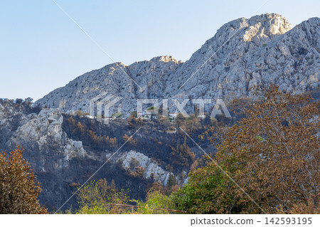 Rocky Croatian mountain landscape with small hillside village in autumn light Rocky Croatian mountain landscape with small hillside village in autumn light 142593195