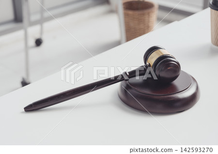 Judge is gavel on a desk, symbolizing law, justice, and legal decision-making in court or auction. Judge is gavel on a desk, symbolizing law, justice, and legal decision-making in court or auction. 142593270