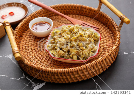 traditional Chinese steamed acacia flowers mixed with flour, served on a vintage wooden tray with dipping sauce. traditional Chinese steamed acacia flowers mixed with flour, served on a vintage wooden tray with dipping sauce. 142593341