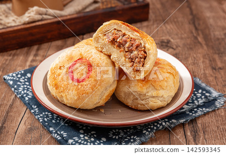 crispy layered meat pie broken open to show juicy beef filling, traditional Asian street food. crispy layered meat pie broken open to show juicy beef filling, traditional Asian street food. 142593345