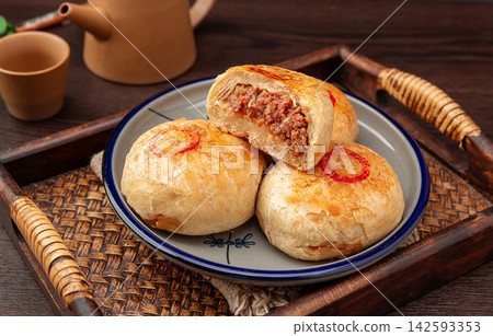 crispy layered meat pie broken open to show juicy beef filling, traditional Asian street food. crispy layered meat pie broken open to show juicy beef filling, traditional Asian street food. 142593353