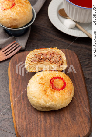 authentic Tianjin Shaobing, crispy baked sesame biscuits filled with seasoned beef. 142593354