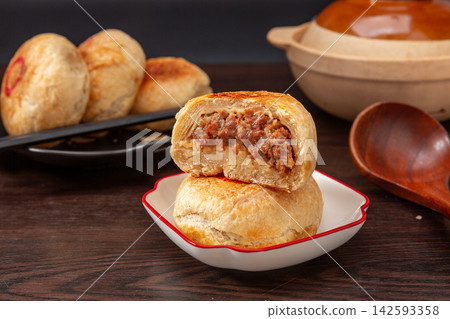 crispy layered meat pie broken open to show juicy beef filling, traditional Asian street food. crispy layered meat pie broken open to show juicy beef filling, traditional Asian street food. 142593358