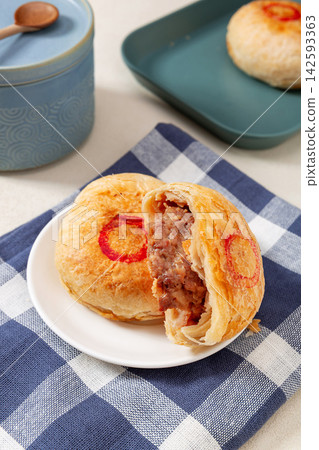 crispy layered meat pie broken open to show juicy beef filling, traditional Asian street food. crispy layered meat pie broken open to show juicy beef filling, traditional Asian street food. 142593363