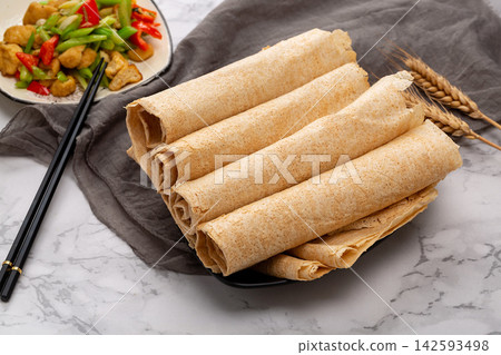 traditional Shandong multigrain crepes wrapped into rolls, authentic Chinese grain tortilla pancakes with dipping sauce. traditional Shandong multigrain crepes wrapped into rolls, authentic Chinese grain tortilla pancakes with dipping sauce. 142593498