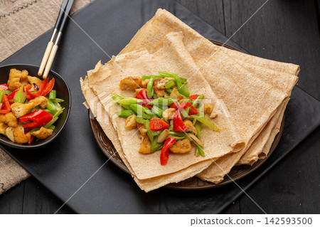 traditional Shandong multigrain crepes wrapped into rolls, authentic Chinese grain tortilla pancakes with dipping sauce. traditional Shandong multigrain crepes wrapped into rolls, authentic Chinese grain tortilla pancakes with dipping sauce. 142593500