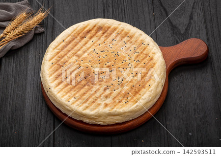 authentic Xinyang thick flatbread with a cut slice, crispy grilled Chinese wheat bread authentic Xinyang thick flatbread with a cut slice, crispy grilled Chinese wheat bread 142593511