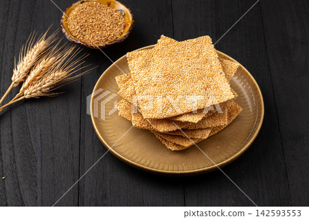 henan style crispy square sesame flatbread tile crackers on black ceramic plate henan style crispy square sesame flatbread tile crackers on black ceramic plate 142593553