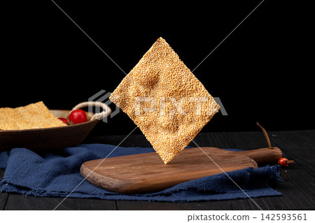 henan style crispy square sesame flatbread tile crackers on black ceramic plate henan style crispy square sesame flatbread tile crackers on black ceramic plate 142593561