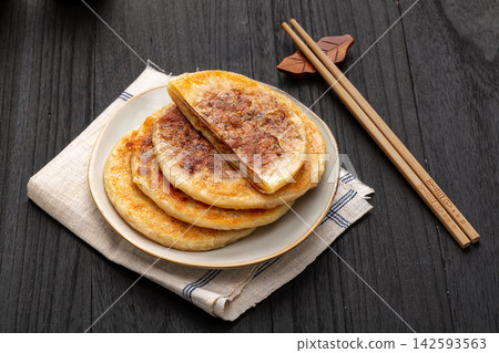 pan fried Chinese meat pies stuffed with black pepper beef filling on ceramic plate pan fried Chinese meat pies stuffed with black pepper beef filling on ceramic plate 142593563