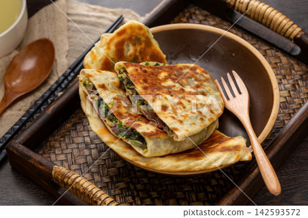 sliced crispy Chinese chive pockets stuffed with scrambled eggs and leeks. sliced crispy Chinese chive pockets stuffed with scrambled eggs and leeks. 142593572