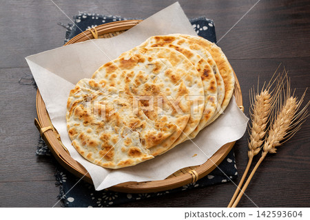 crispy Chinese flatbread stuffed with savory pork and preserved mustard greens. crispy Chinese flatbread stuffed with savory pork and preserved mustard greens. 142593604