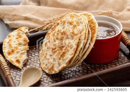 crispy Chinese flatbread stuffed with savory pork and preserved mustard greens. crispy Chinese flatbread stuffed with savory pork and preserved mustard greens. 142593605