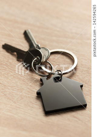 Keys with house shape keychain representing home ownership Keys with house shape keychain representing home ownership 142594265
