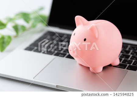 Laptop and piggy bank Laptop and piggy bank 142594825
