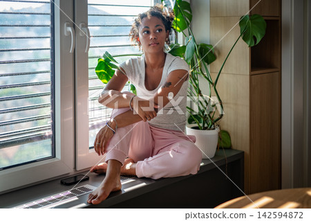 Female diabetes patient with CGM sensor in bright apartment Female diabetes patient with CGM sensor in bright apartment 142594872