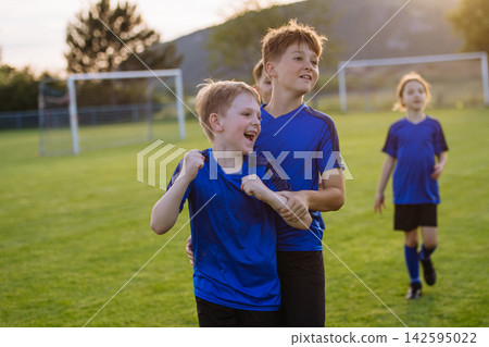 Young football team celebrating goal. Young football team celebrating goal. 142595022