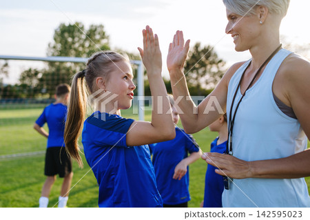Young football players and coaches building team spirit before match. Young football players and coaches building team spirit before match. 142595023